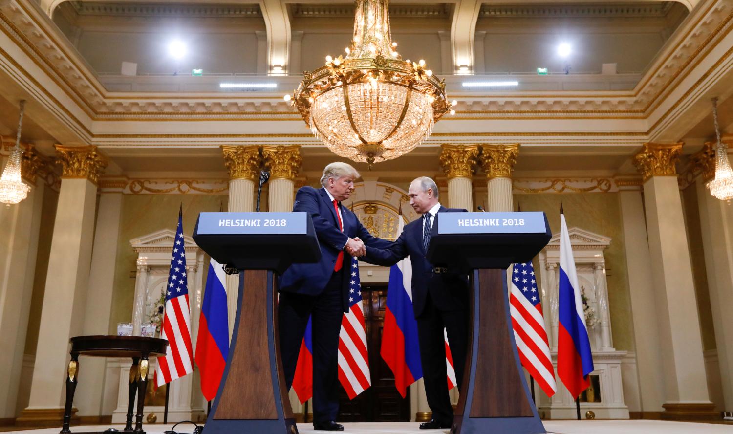 U.S. President Donald Trump and Russia's President Vladimir Putin shake hands during a joint news conference after their meeting in Helsinki, Finland, July 16, 2018. REUTERS/Kevin Lamarque - RC165B49D900