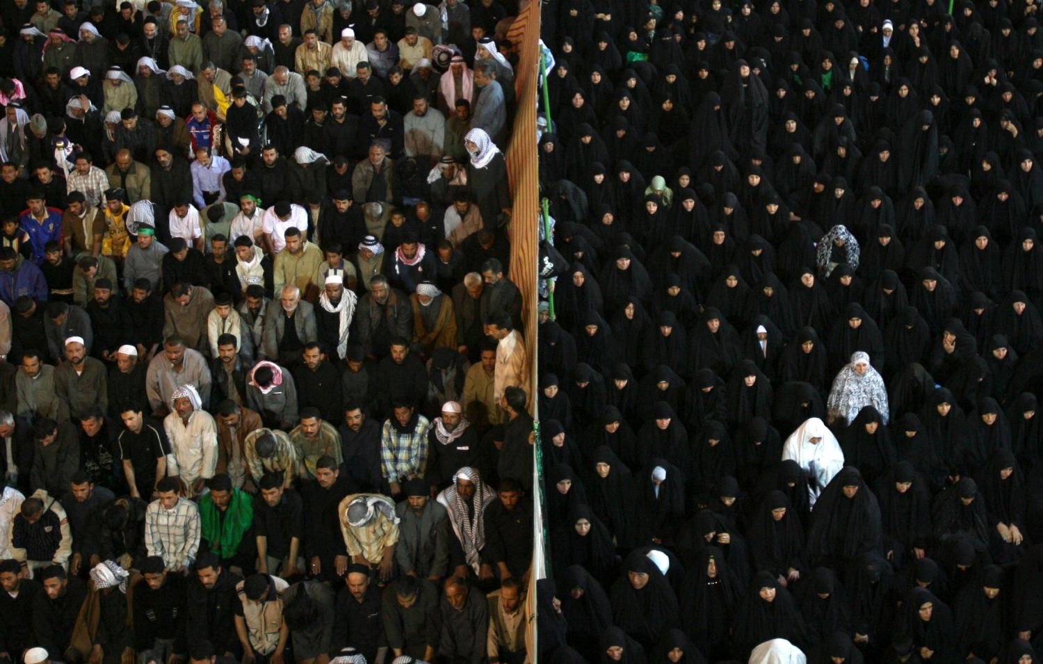 Male and female pilgrims are separated by a barrier as they pray at the Imam Hussein shrine during the Arbain religious event in the holy city of Kerbala, 110 km (70 miles) south of Baghdad March 8, 2007. More than a million Shi'ite Muslim pilgrims poured into Iraq 's holy city of Kerbala to mark Arbain, the end of a 40-day mourning period since Ashura, which marks the death of Prophet Mohammad's grandson Imam Hussein in 680AD.  REUTERS/Thaier al-Sudani (IRAQ) - GM1DUTSTBNAA
