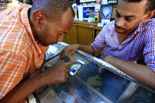 Venders play Ludo using iPhone Games, while waiting in a store, at a market in Khartoum, Sudan July 3, 2017. REUTERS/Mohamed Nureldin Abdallah - RC1F5A668EE0