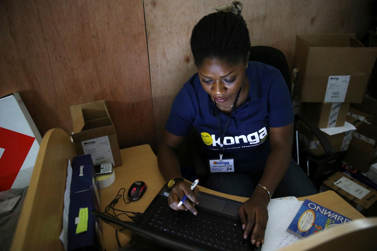 A staff inputs data into a computer at the warehouse of Konga online shopping company in Ilupeju district in Nigeria's commercial capital Lagos September 13, 2013.  REUTERS/Akintunde Akinleye(NIGERIA - Tags: BUSINESS EMPLOYMENT) - GM1E9BB19TI01