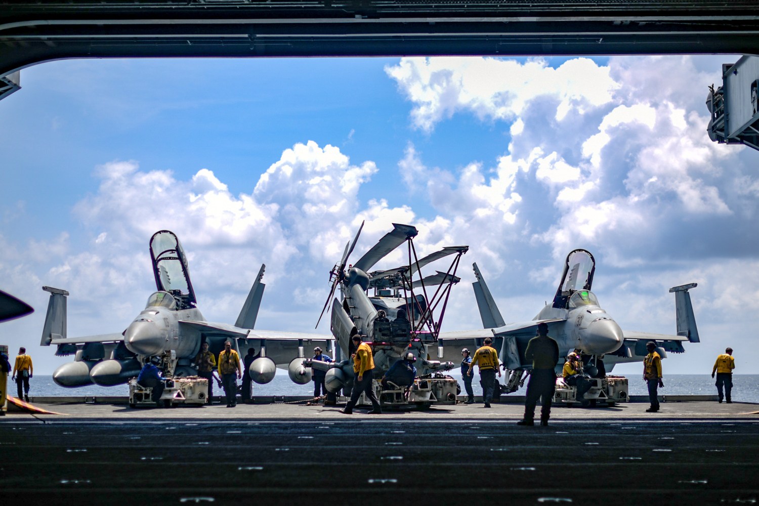U.S. Navy sailors move aircraft from an elevator into the hangar bay of the aircraft carrier USS Theodore Roosevelt in the South China Sea April 8, 2018. Picture taken April 8, 2018. U.S. Navy/Mass Communication Specialist Seaman Michael Hogan/Handout via REUTERS.  ATTENTION EDITORS - THIS IMAGE WAS PROVIDED BY A THIRD PARTY - RC19F1104180