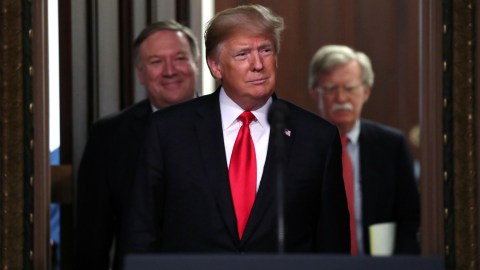 U.S. President Donald Trump arrives flanked by Secretary of State Mike Pompeo (L) and U.S. National Security Advisor John Bolton (R) for the annual meeting of the Interagency Task Force to Monitor and Combat Trafficking in Persons at the White House in Washington, U.S., October 11, 2018. REUTERS/Jonathan Ernst - RC1E1B893A40