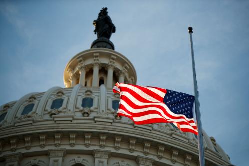 The American flag flies at half staff at the US Capitol prior to the service for former President George H. W. Bush at the US Capitol in Washington, DC, USA, 03 December 2018. Shawn Thew/Pool via REUTERS - RC1FFB18A0B0