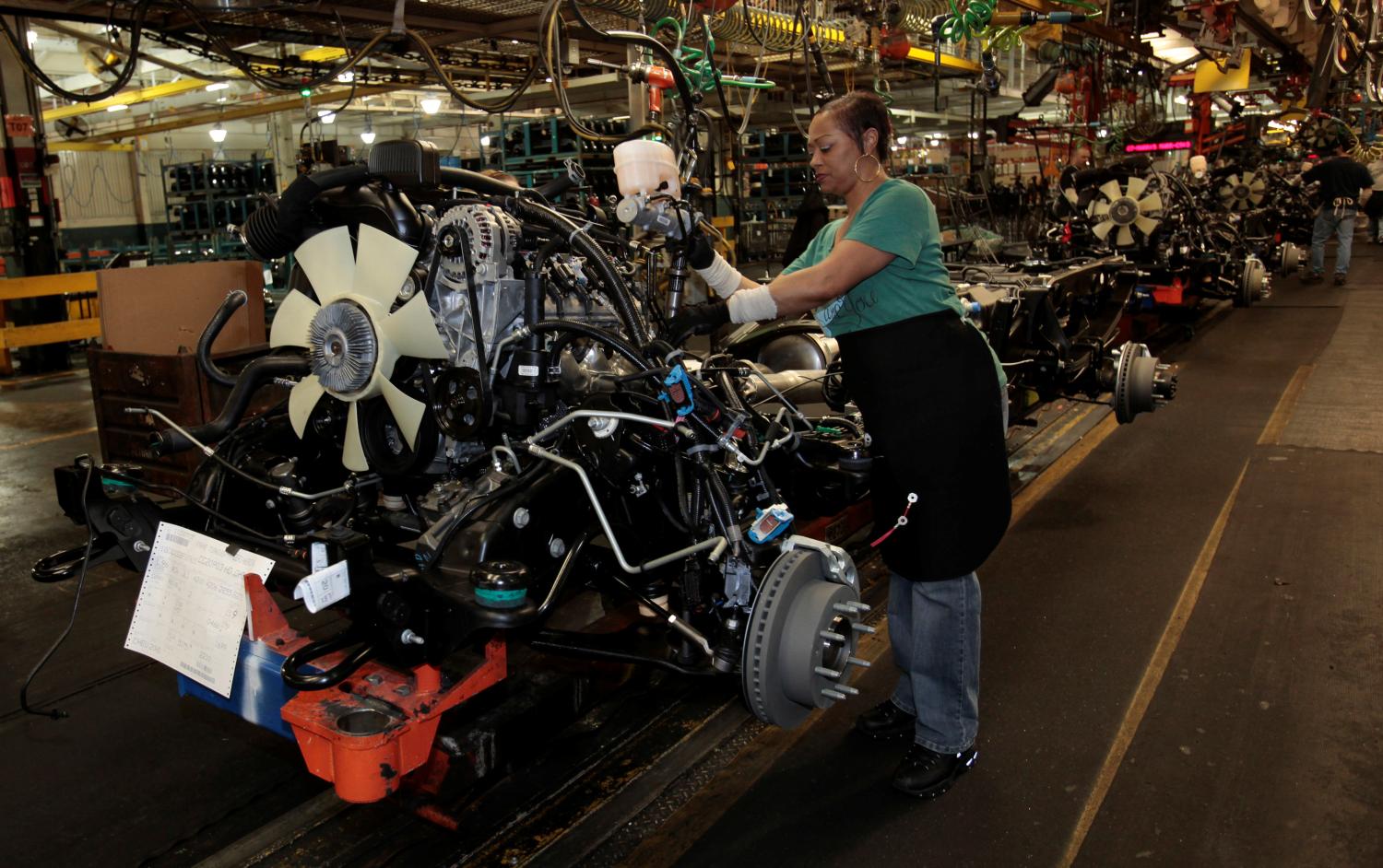 FILE PHOTO: General Motors auto assembly worker Karen Garner works on assembling engines for Chevrolet Silverado's and GMC Sierra pickup trucks at the Flint Assembly in Flint, Michigan January 24, 2011.  REUTERS/Rebecca Cook/File Photo - RC1C42526E40