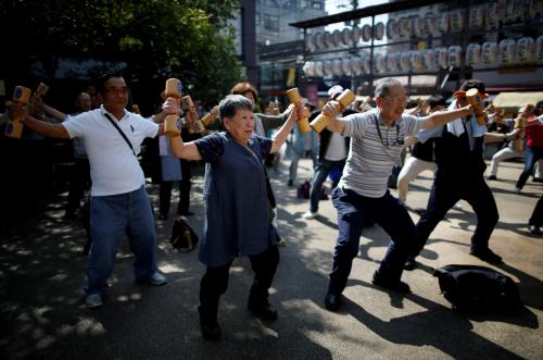 Participants including elderly and middle-aged people exercise with wooden dumbbells during a health promotion event to mark Japan's "Respect for the Aged Day" at a temple in Tokyo's Sugamo district, an area popular among the Japanese elderly, September 17, 2018. REUTERS/Issei Kato      TPX IMAGES OF THE DAY - RC14EDF2A330