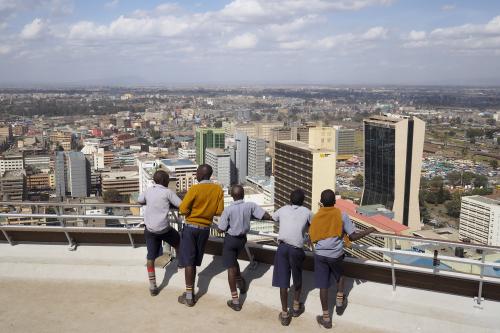 Schoolchildren look out at the central business district from atop the Kenya International Convention Centre in Nairobi, Kenya, August 25, 2015. REUTERS/Joe Penney - GF10000182190