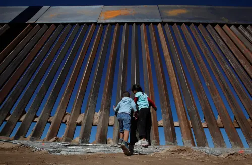 Children play at a newly built section of the U.S.-Mexico border wall at Sunland Park, U.S. opposite the Mexican border city of Ciudad Juarez, Mexico November 18, 2016. Picture taken from the Mexico side of the U.S.-Mexico border. Picture taken November 18, 2016. REUTERS/Jose Luis Gonzalez - RC13C47E2660