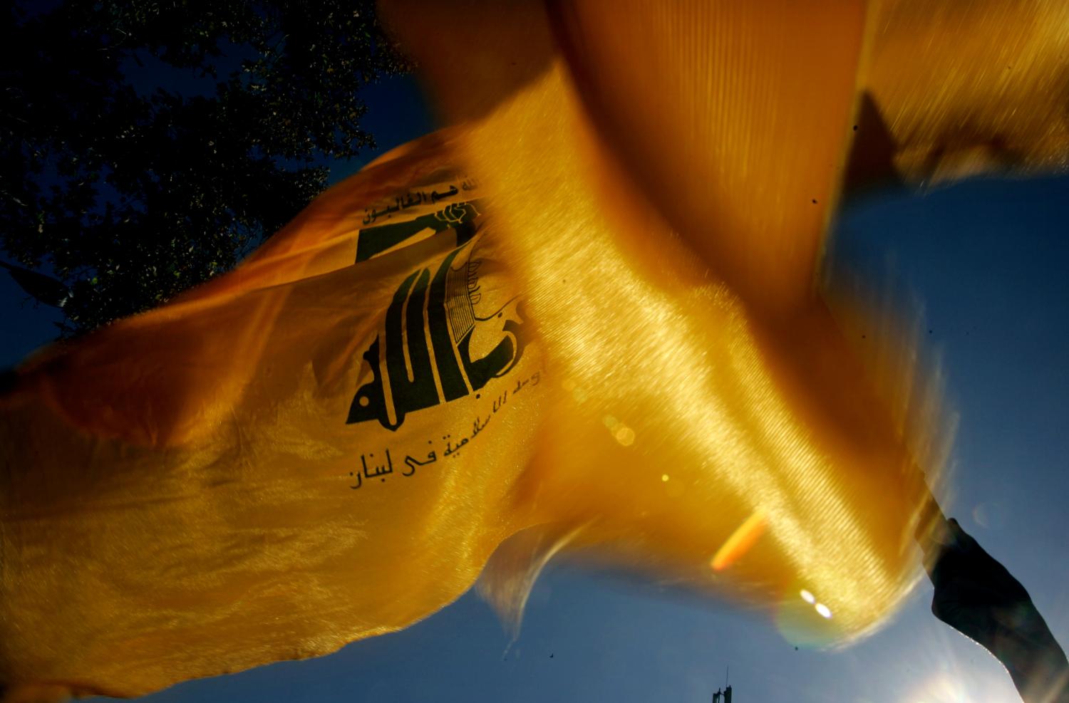 An Iranian protester (unseen) waves the Lebanon's Hezbollah's flag during a rally in front of the former U.S. embassy in Tehran to mark the anniversary of Student's Day November 4, 2006. Thousands of Iranians on Saturday chanted "Death to America" outside the former U.S. embassy which students stormed on this day in 1979, renewing Iran's defiance at a time when it faces possible sanctions for its nuclear work. REUTERS/Morteza Nikoubazl(IRAN) - GM1DTWFPDLAA