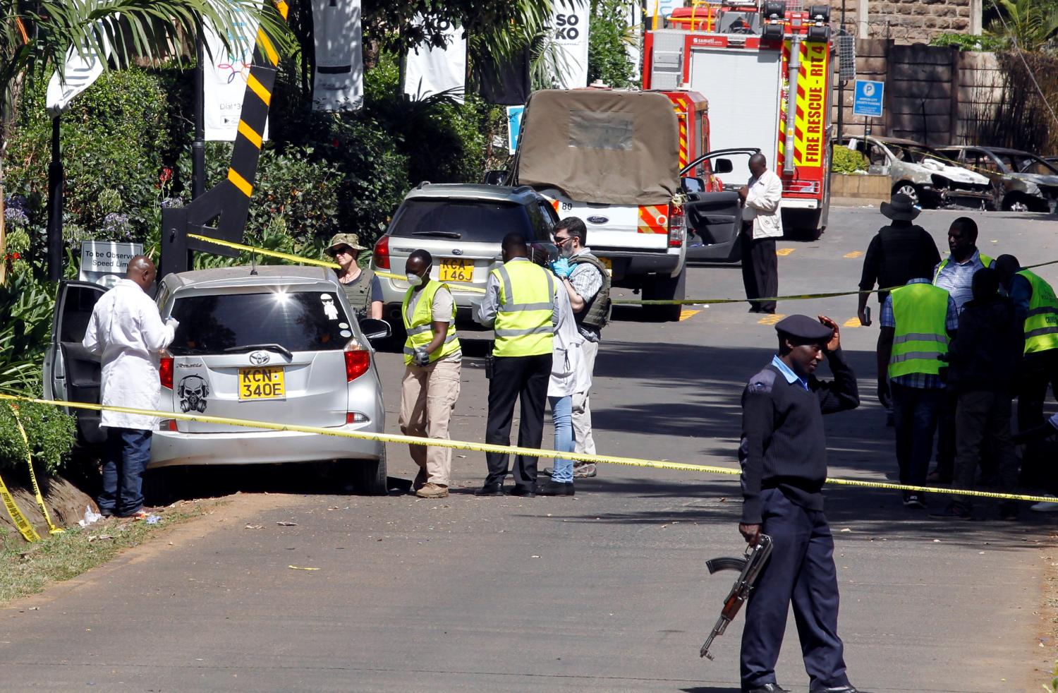 Kenyan policemen and explosives experts gather evidence from the car suspected to have been used by the attackers outside the scene where explosions and gunshots were heard at The DusitD2 complex, in Nairobi, Kenya January 17, 2019. REUTERS/Njeri Mwangi - RC1EDB13C140