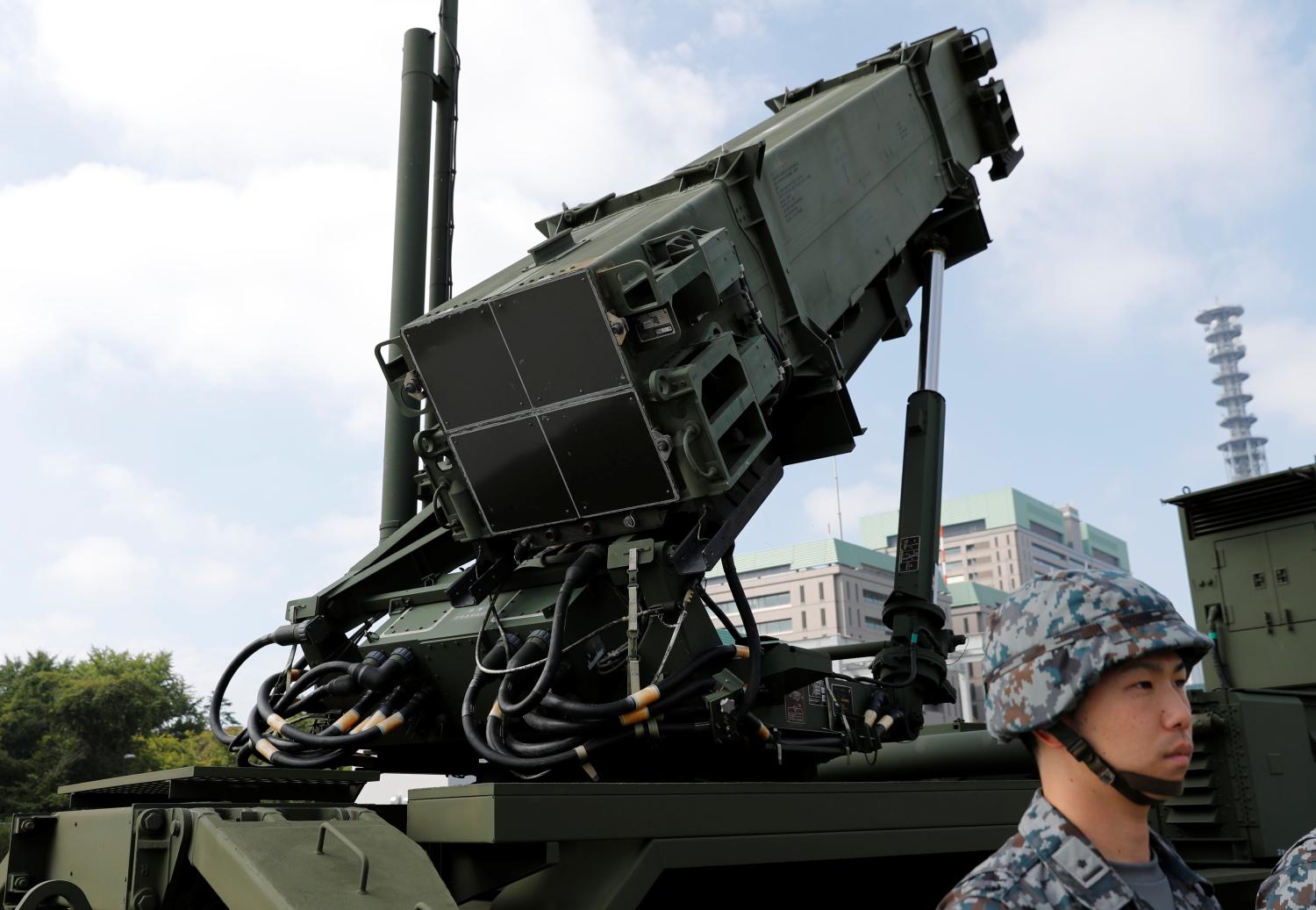 A Japan Self-Defense Forces (JSDF) soldier stands in front of Patriot Advanced Capability-3 (PAC-3) missile unit before Japan's Chief Cabinet Secretary Yoshihide Suga reviews the unit at the Defense Ministry in Tokyo, Japan, October 8, 2017. REUTERS/Kim Kyung-Hoon - RC1B33E78DD0