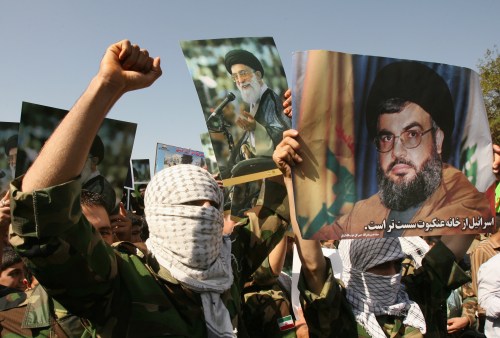 Demonstrators hold pictures of Lebanese Hezbollah leader Sayyed Hassan Nasrallah (R) and Iran's Supreme Leader Ayatollah Ali Khamenei (C) during Jerusalem Day demonstration in Tehran October 20, 2006. REUTERS/Caren Firouz (IRAN) - GM1DTTJIUTAA