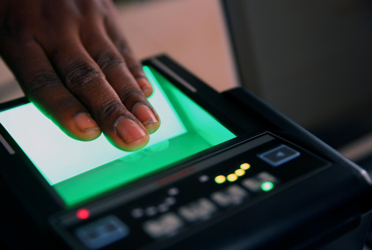 An official records finger prints of a person during voter's card registration for the country's 2019 presidential and general election, at the Independent National Electoral Commission (INEC) in Karu district in Abuja, Nigeria January 31, 2018. REUTERS/Afolabi Sotunde - RC17CD6DFB00