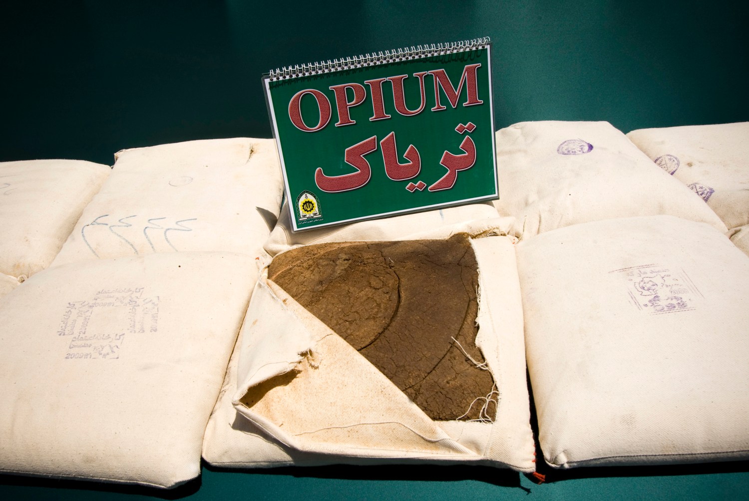 Confiscated opium is seen on display during a ceremony concluding anti-narcotics manoeuvres in Zahedan, 1,605 kilometers (1,003 miles) southeast of Tehran May 20, 2009. The head of the U.N. crime agency praised Iran during a visit on Wednesday for curbing the flow of smuggled heroin from Afghanistan and helping keep the drug off Western streets.  Picture taken May 20, 2009.  REUTERS/Caren Firouz (IRAN CRIME LAW POLITICS SOCIETY) - GM1E55L1AOY01