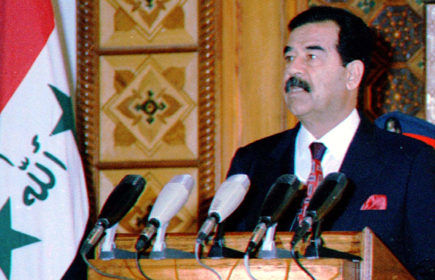 Iraqi President Saddam Hussein addresses the eigth anniversary of the Great Victory Day August 8. In his address marking the ceasefire in the 1980-88 Iraq-Iran war, Saddam rejected Western government accusations that he had spent a fortune on building palaces for himself while his people enjured poverty. He made no mention of his country's oil-for-food deal with the U.N. whose implementation the U.S. approved on Wednesday. - PBEAHUMWIBM