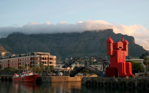 Table Mountain looms over Cape Town's Waterfront district, September 30, 2010. With its spectacular mountains and gorgeous beaches, Cape Town is perfect for outdoor activities like rock climbing, wind surfing and cycling. And after seeing lions and elephants on safari further north, you can watch whales, penguins and seals in the waters around the Cape of Good Hope. Picture taken September 30, 2010. To match Reuters Life! TRAVEL-CAPETOWN REUTERS/Steve James (SOUTH AFRICA - Tags: TRAVEL) - GM1E6CB0DM801
