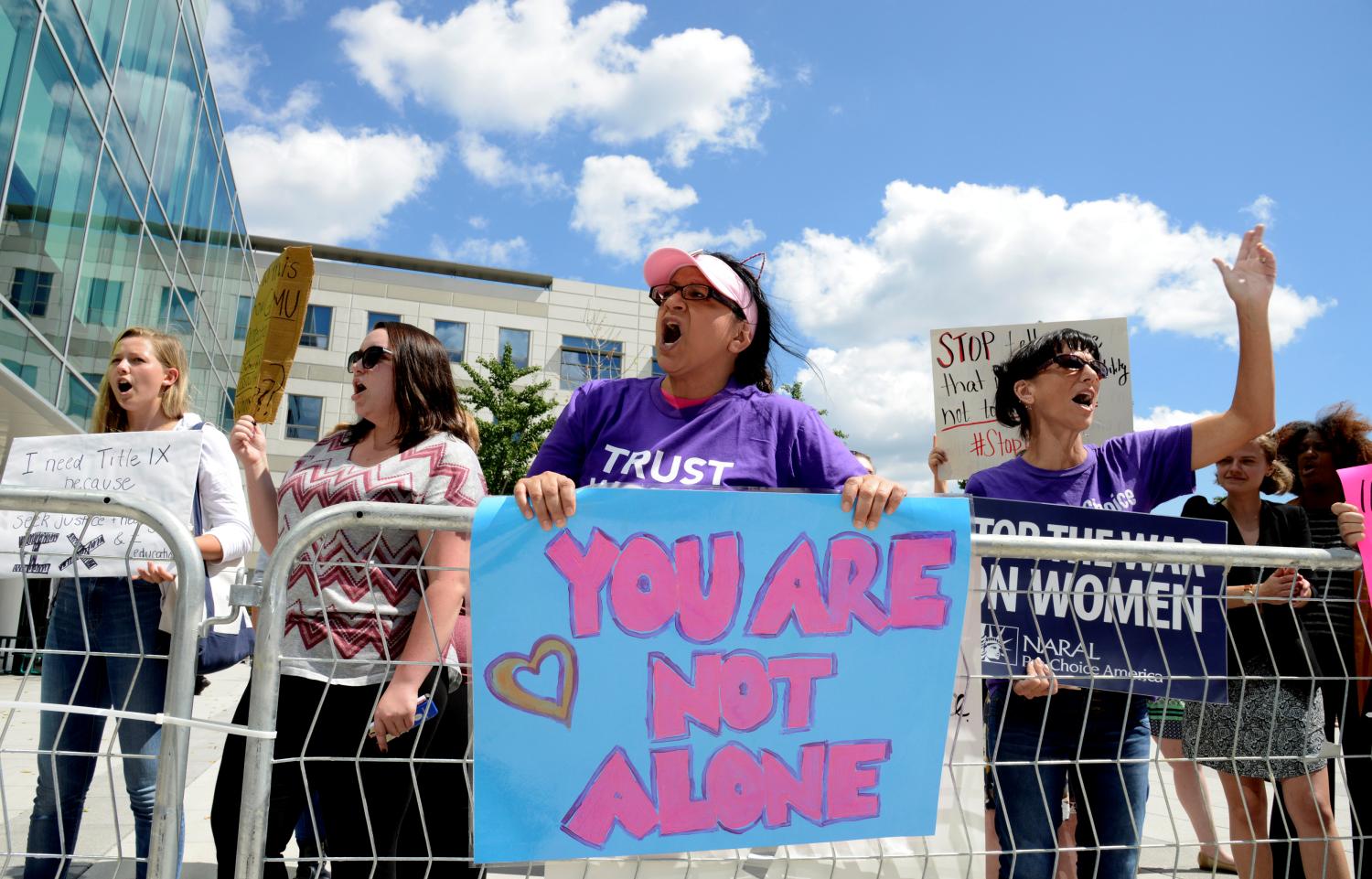 A group of demonstrators gather outside Founders Hall where Education Secretary Betsy DeVos delivered a major policy address on Title IX enforcement, which in college covers sexual harassment, rape and assault, at George Mason University, in Arlington, Virginia, U.S., September 7, 2017.           REUTERS/Mike Theiler - RC11F2E31210