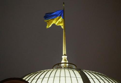 A Ukrainian national flag flies over the parliament building (Verkhovna Rada) during a parliament session to review a proposal by President Petro Poroshenko to introduce martial law for 60 days after Russia seized Ukrainian naval ships off the coast of Russia-annexed Crimea, in Kiev, Ukraine, November 26, 2018.  REUTERS/Gleb Garanich - RC1BD2505A10