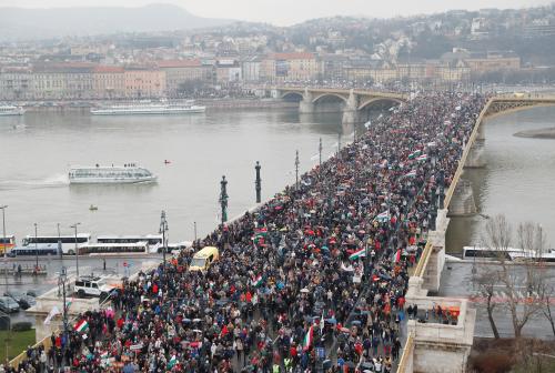 People walk on the Margaret bridge as they attend Hungarian march at a pro-Orban rally during Hungary's National Day celebrations, which also commemorates the 1848 Hungarian Revolution against the Habsburg monarchy, in Budapest, Hungary March 15, 2018. REUTERS/Bernadett Szabo - RC1873B30490