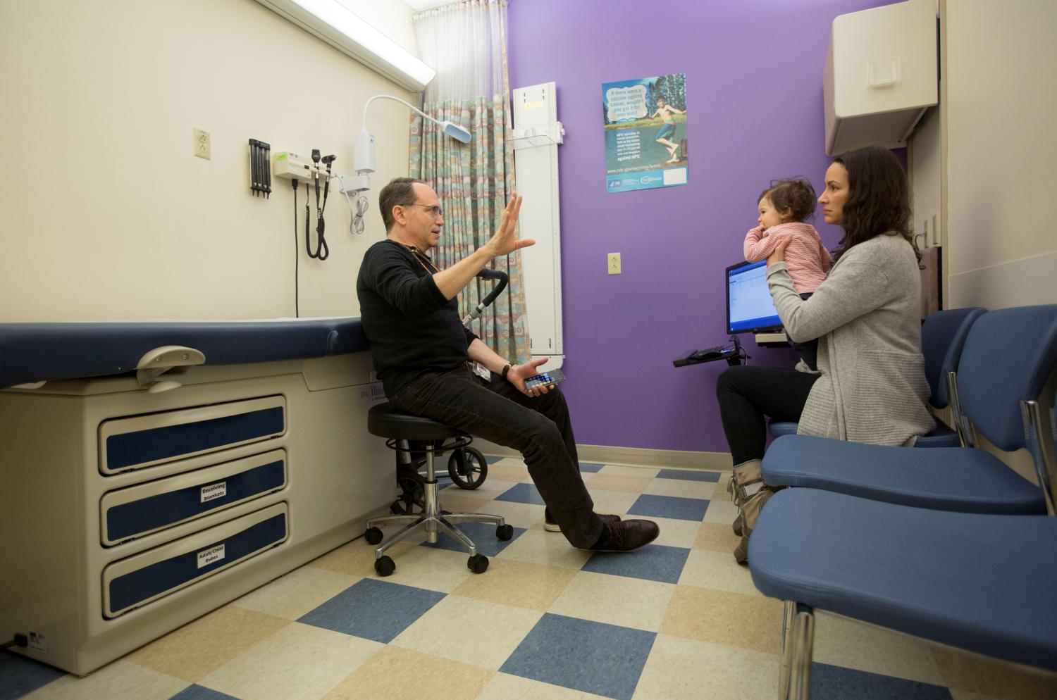 Dr. Benjamin Hoffman (L) speaks with Nancy Minoui about 9 month old Marion Burgess, who suffers from a chronic heart condition, at an appointment at the Dornbecher Children's hospital in Portland, Oregon, U.S. December 6, 2017. Picture taken December 6, 2017. REUTERS/Natalie Behring - RC14A7754950