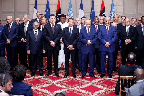 French President Emmanuel Macron, Libyan Prime Minister Fayez al-Sarraj, Khalifa Haftar, the military commander who dominates eastern Libya, and the participants of the International Conference on Libya listen to a verbal agreement between the various parties regarding the organization of a democratic election this year at the Elysee Palace in Paris, France, May 29, 2018.  Etienne Laurent/Pool via Reuters - RC150A52E560