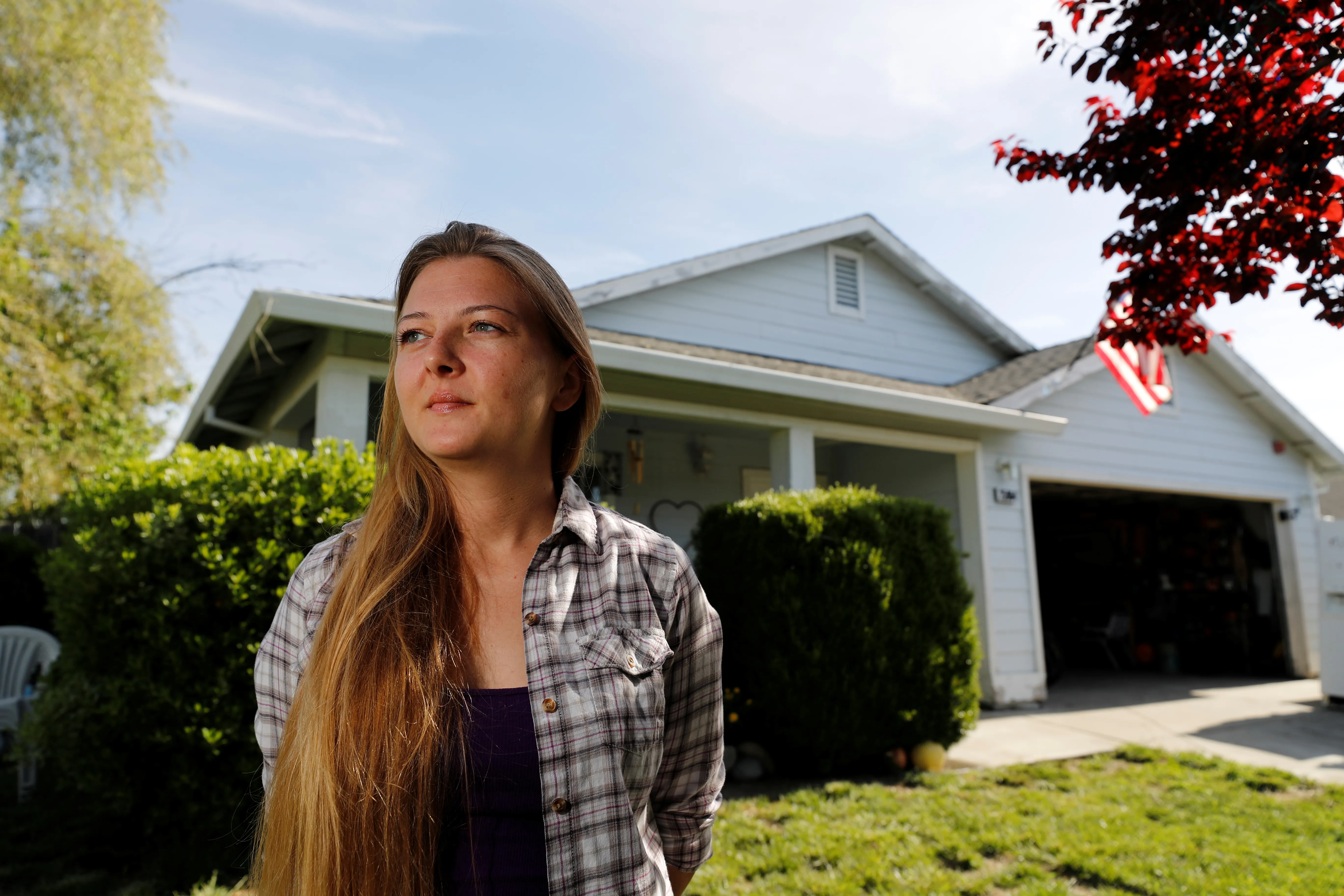Whitney Hurst stands in front of the house that she rents from Invitation Homes in Esparto, California, U.S. April 24, 2018. Picture taken April 24, 2018.  To match Special Report USA-HOUSING/INVITATION.  REUTERS/Fred Greaves - RC17AE180000