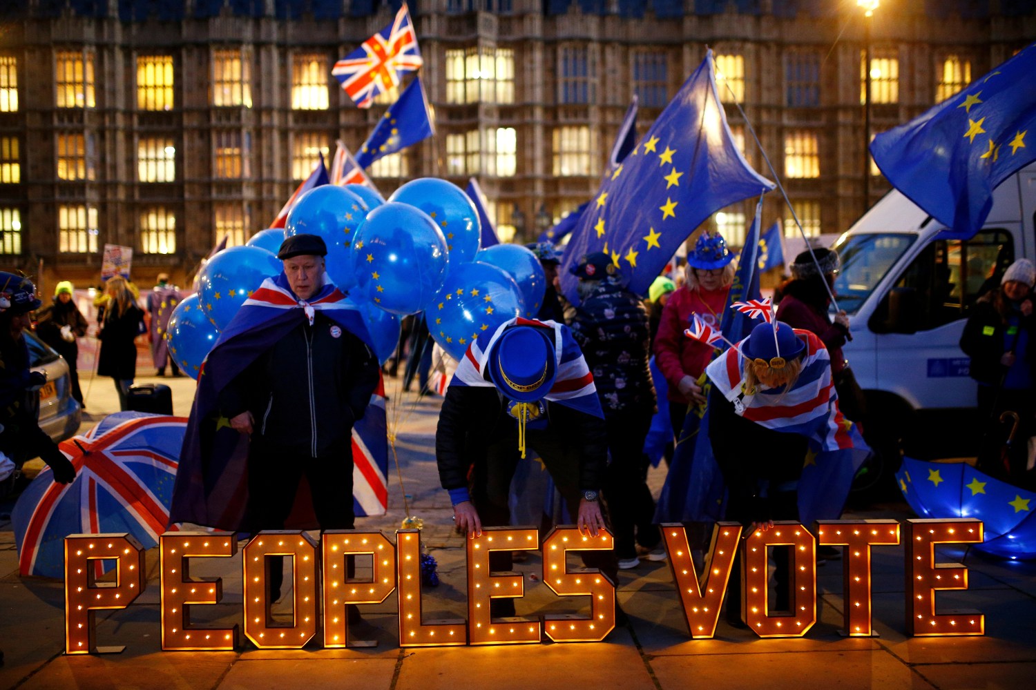 Anti-Brexit protesters stand next to an illuminated sign outside the Houses of Parliament in London, Britain, December 10, 2018. REUTERS/Henry Nicholls     TPX IMAGES OF THE DAY - RC18D2DB4050