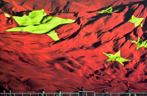 Spectators display a huge Chinese national flag during the Nanning International Arts Festival of Folk Songs, the gala show for the opening of the ninth China-ASEAN expo, in Guangxi province September 21, 2012. Picture taken September 21, 2012.  REUTERS/Stringer (CHINA - Tags: SOCIETY TPX IMAGES OF THE DAY) CHINA OUT. NO COMMERCIAL OR EDITORIAL SALES IN CHINA - GM1E89M19VY01