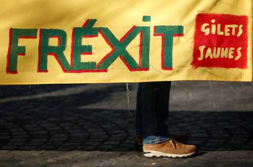 The word "Frexit" is seen on a banner as protesters take part in a demonstration by the "yellow vests" movement in Paris, France, February 16, 2019. REUTERS/Benoit Tessier - RC1752CAE600