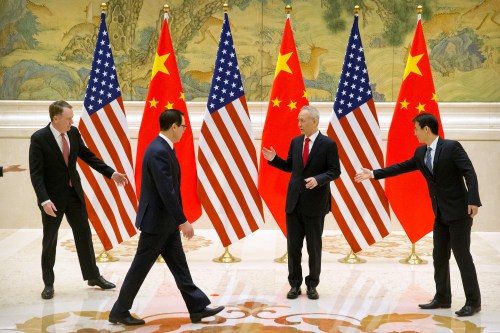 Aides gesture as U.S. Trade Representative Robert Lighthizer, Chinese Vice Premier and lead trade negotiator Liu He, and U.S. Treasury Secretary Steven Mnuchin line up for a photo before the opening session of trade negotiations at the Diaoyutai State Guesthouse in Beijing, Thursday, Feb. 14, 2019. Mark Schiefelbein/Pool via REUTERS - RC1BB7FBA400