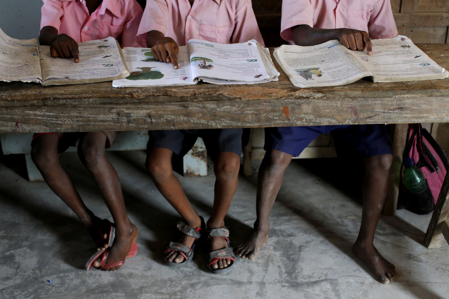 Students from a primary school read books inside a classroom on Ghoramara Island, India, November 16, 2018. Ghoramara Island, part of the Sundarbans delta on the Bay of Bengal, has nearly halved in size over the past two decades, according to village elders. REUTERS/Rupak De Chowdhuri  SEARCH "CHOWDHURI COASTLINE" FOR THIS STORY. SEARCH "WIDER IMAGE" FOR ALL STORIES. - RC16F935BB30
