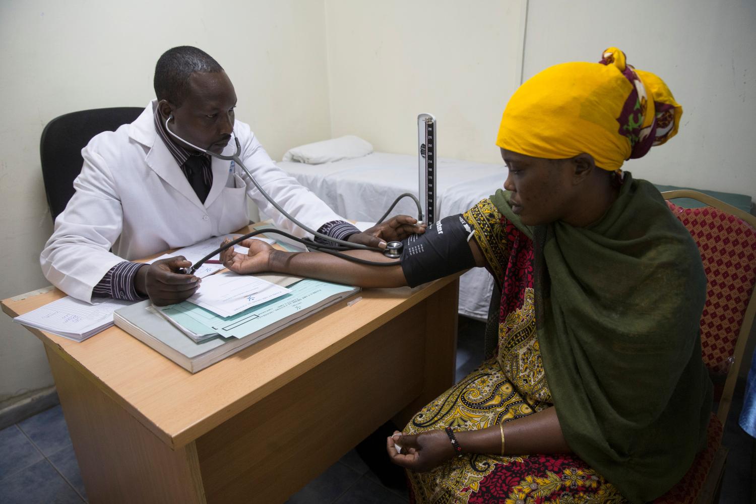 A patient gets examined by a health worker during a visit by Netherlands Minister for Trade and Development Cooperation Lilianne Ploumen at a Family Health Options clinic in the Kibera slums in Nairobi, Kenya, May 16, 2017. picture taken May 16, 2017.REUTERS/Baz Ratner - RC1DABC9A570