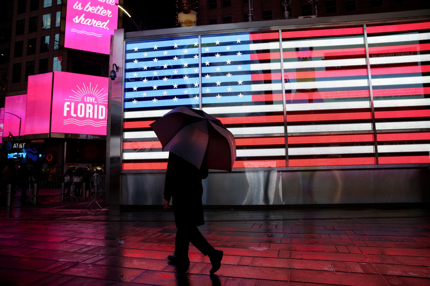 A man walks through the rain in Times Square in Manhattan, New York, U.S., February 10, 2018. REUTERS/Amr Alfiky - RC1F10244800