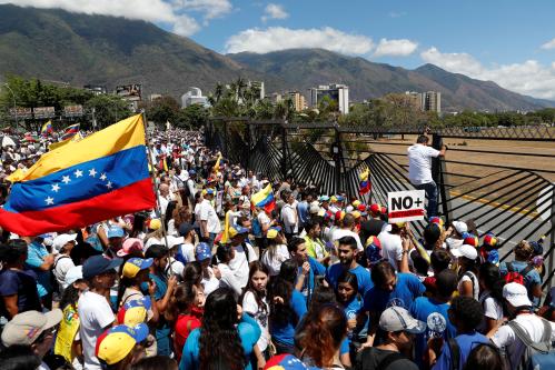 Supporters of the Venezuelan opposition leader Juan Guaido, who many nations have recognized as the country's rightful interim ruler, take part in a rally to demand President Nicolas Maduro to allow humanitarian aid to enter the country, outside of an Air Force base in Caracas, Venezuela February 23, 2019. REUTERS/Carlos Garcia Rawlins - RC1305D0E9B0