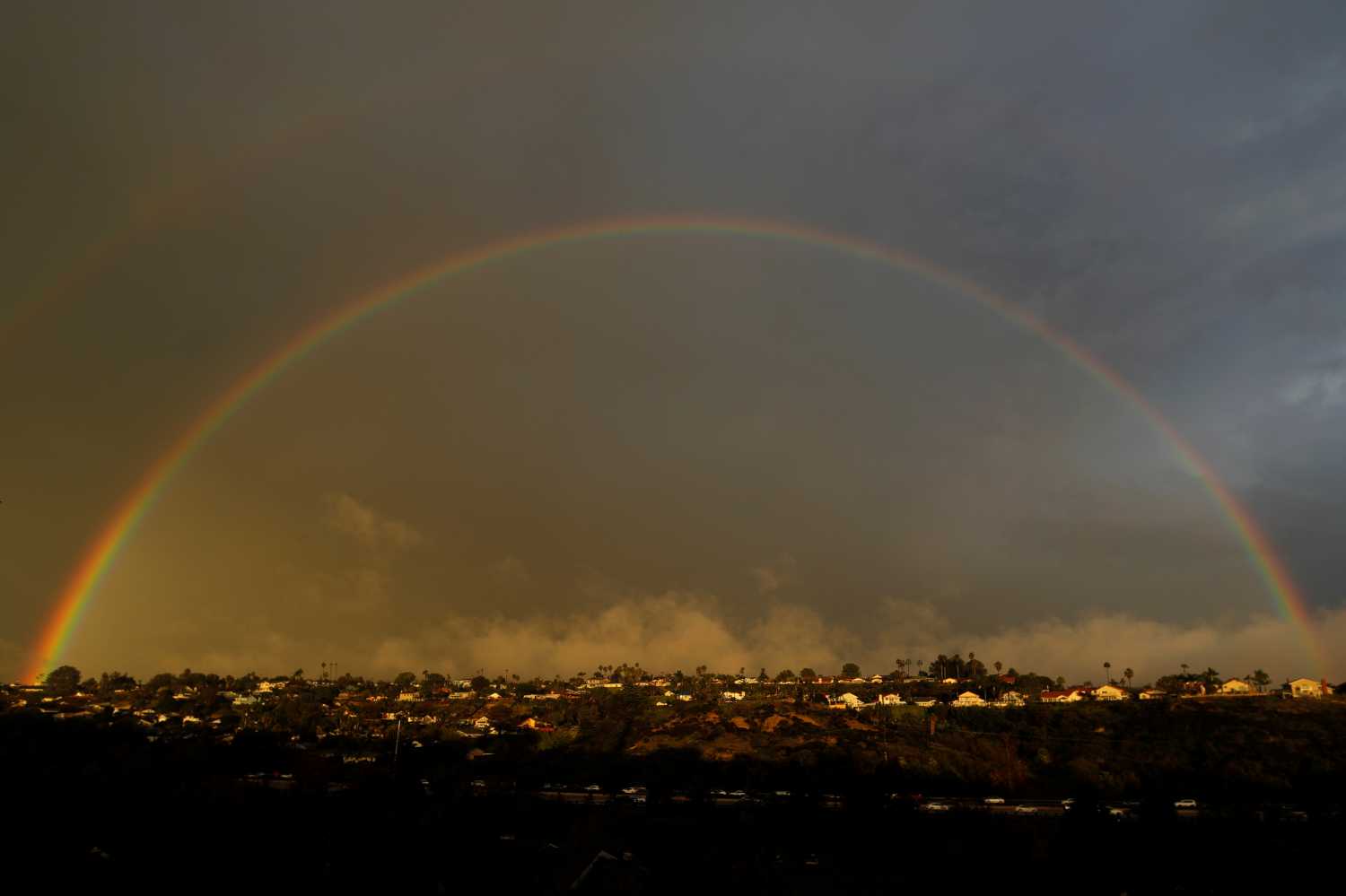 A rainbow appears above homes on a hillside following a rain storm in Encinitas, California, U.S., January 31, 2019.   REUTERS/Mike Blake - RC1D4A71D2D0