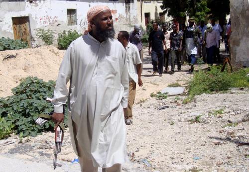 Sheikh Muktar Robow Abuu Mansuur, a senior official of the Al-Shabaab group, walks along the frontline, north of Mogadishu, June 29, 2010. REUTERS/Omar Faruk (SOMALIA - Tags: POLITICS CIVIL UNREST) - GM1E66T1U5E01