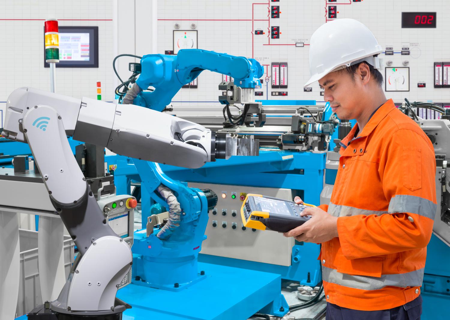 Man working in factory with heavy machinery