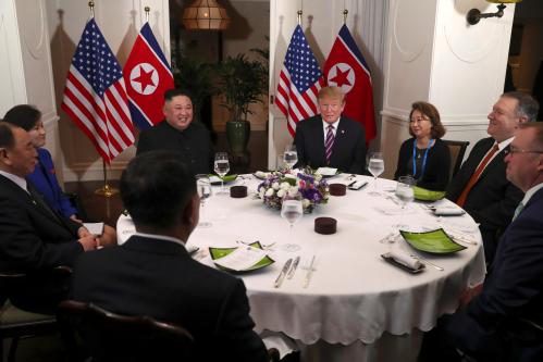 U.S. President Donald Trump and North Korean leader Kim Jong Un sit down for a dinner during the second U.S.-North Korea summit at the Metropole Hotel in Hanoi, Vietnam February 27, 2019. Also pictured at right are U.S. Secretary of State Mike Pompeo and Acting White House Chief of Staff Mick Mulvaney, at left are Vice Chairman of the North Korean Workers' Party Central Committee Kim Yong Chol and North Korea's Foreign Minister Ri Yong Ho (obscured)   REUTERS/Leah Millis - RC179F888B20