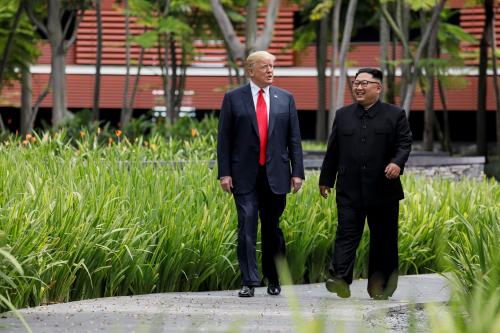 U.S. President Donald Trump and North Korea's leader Kim Jong Un walk together before their working lunch during their summit at the Capella Hotel on the resort island of Sentosa, Singapore June 12, 2018. Picture taken June 12, 2018. REUTERS/Jonathan Ernst - RC116285B8A0