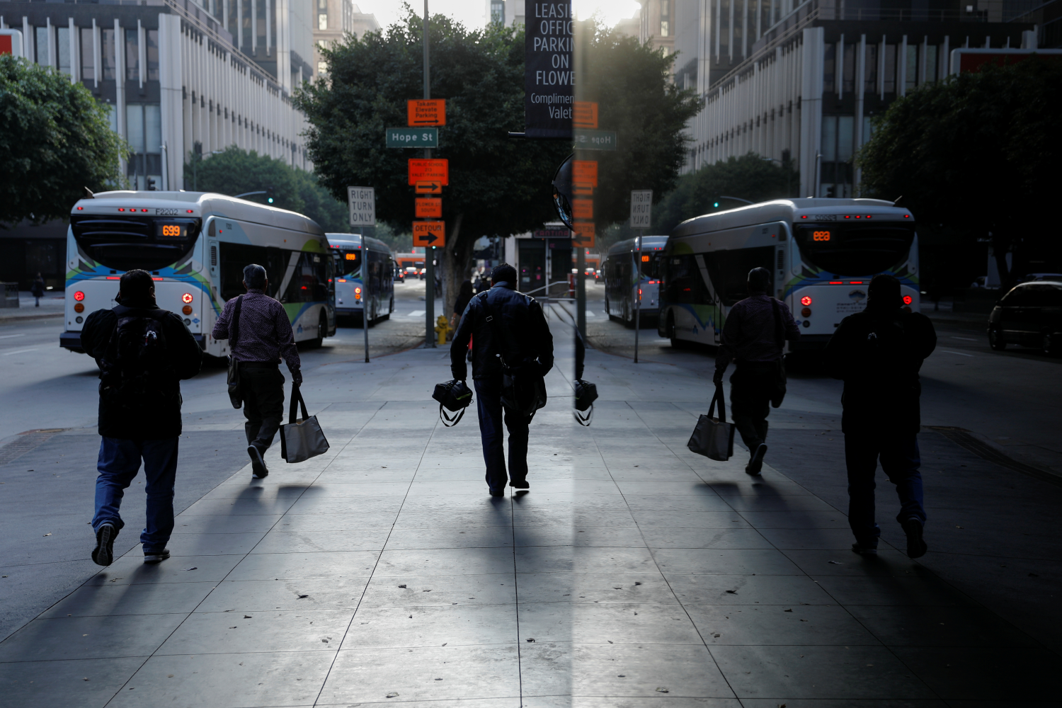 Commuters make their way to work after departing a city bus in downtown Los Angeles, California, U.S., October 24, 2018. REUTERS/Mike Blake