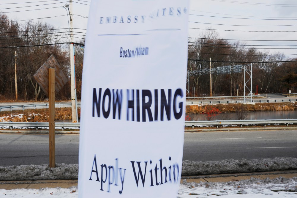 A sign advertises open jobs at an Embassy Suites hotel in Waltham, Massachusetts, U.S., December 13, 2017.   REUTERS/Brian Snyder - RC1C64DACE20