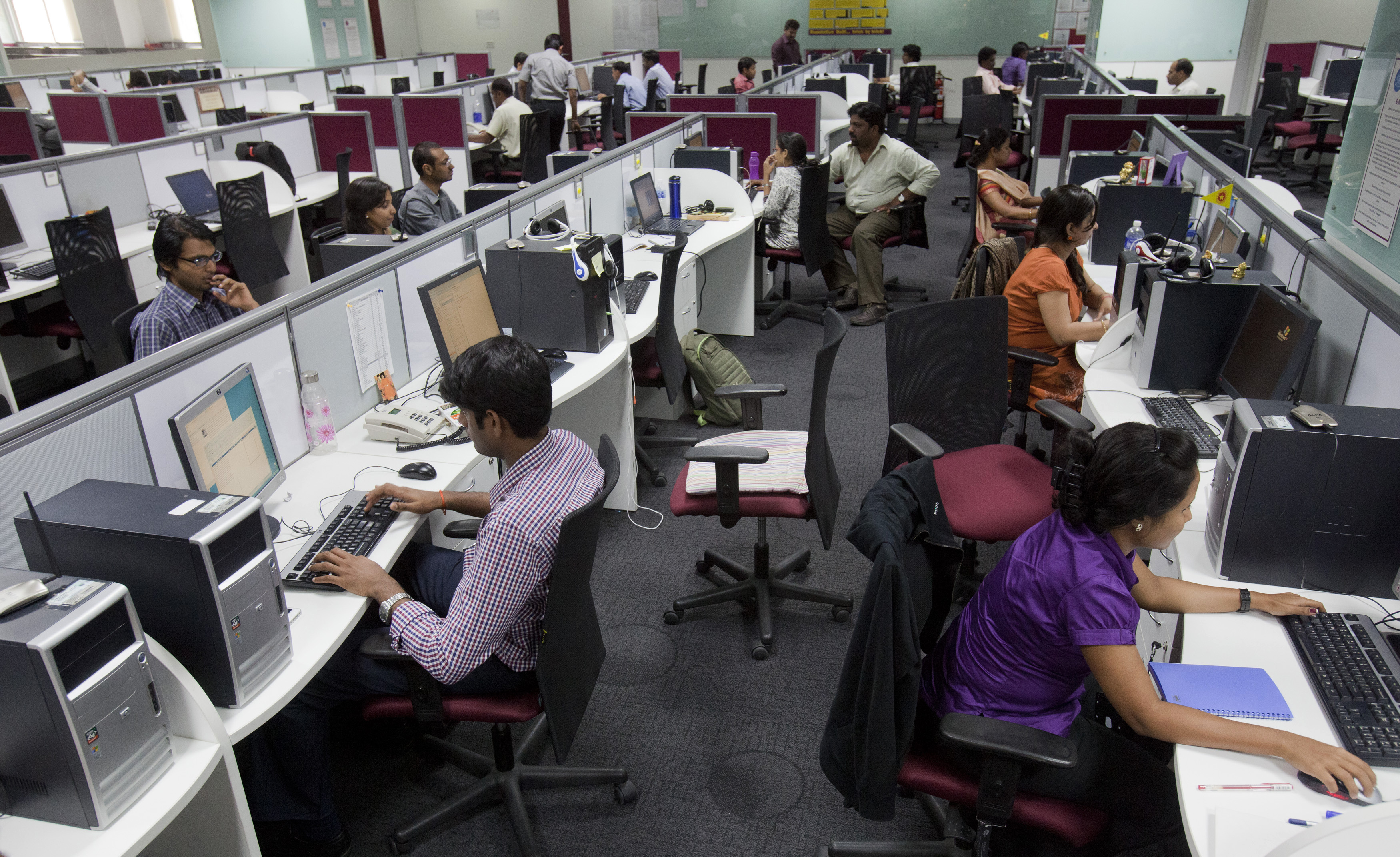 Workers are seen at their workstations on the floor of an outsourcing centre in Bangalore, February 29, 2012. India's IT industry, with Bangalore firms forming the largest component, is now worth an annual $100 billion and growing 14 percent per year, one of the few bright spots in an economy blighted by policy stagnation and political instability. Picture taken on February 29, 2012. To match Insight INDIA-OUTSOURCING/   REUTERS/Vivek Prakash (INDIA - Tags: BUSINESS EMPLOYMENT SCIENCE TECHNOLOGY) - GM1E8450SWY01