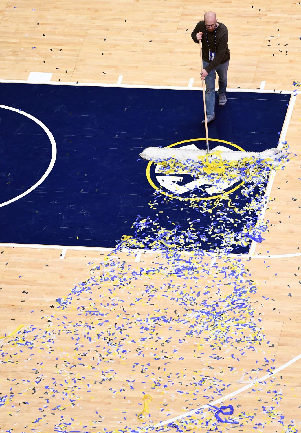 Mar 17, 2019; Nashville, TN, USA; A member of the Bridgestone Arena crew sweeps confetti off the court after a win by the Auburn Tigers over the Tennessee Volunteers in the SEC conference tournament championship game at Bridgestone Arena. Mandatory Credit: Christopher Hanewinckel-USA TODAY Sports - 12368716