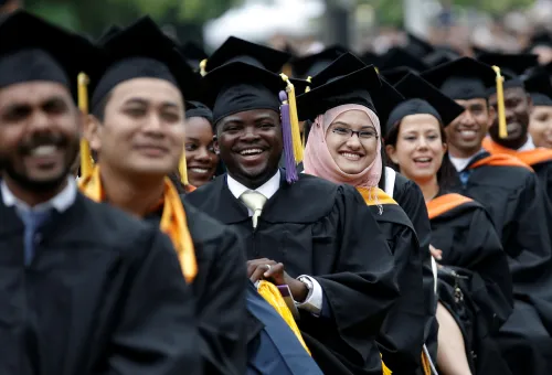Graduating students of the City College of New York sit together in their caps and gowns as they listen to U.S. first lady Michelle Obama's address during the College's commencement ceremony in the Harlem section of Manhattan, New York, U.S., June 3, 2016. REUTERS/Mike Segar - D1BETHVBVCAA