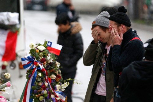 Jesse Hughes (R) and Julian Dorio, members of Eagles of Death Metal band, mourn in front of the Bataclan concert hall to pay tribute to the shooting victims in Paris, France, December 8, 2015. The band Eagles of Death Metal, known as EODM, was performing at the Bataclan when the deadliest of the Islamic State attacks took place in Paris on November 13.     REUTERS/Charles Platiau  TPX IMAGES OF THE DAY - PM1EBC8157B01
