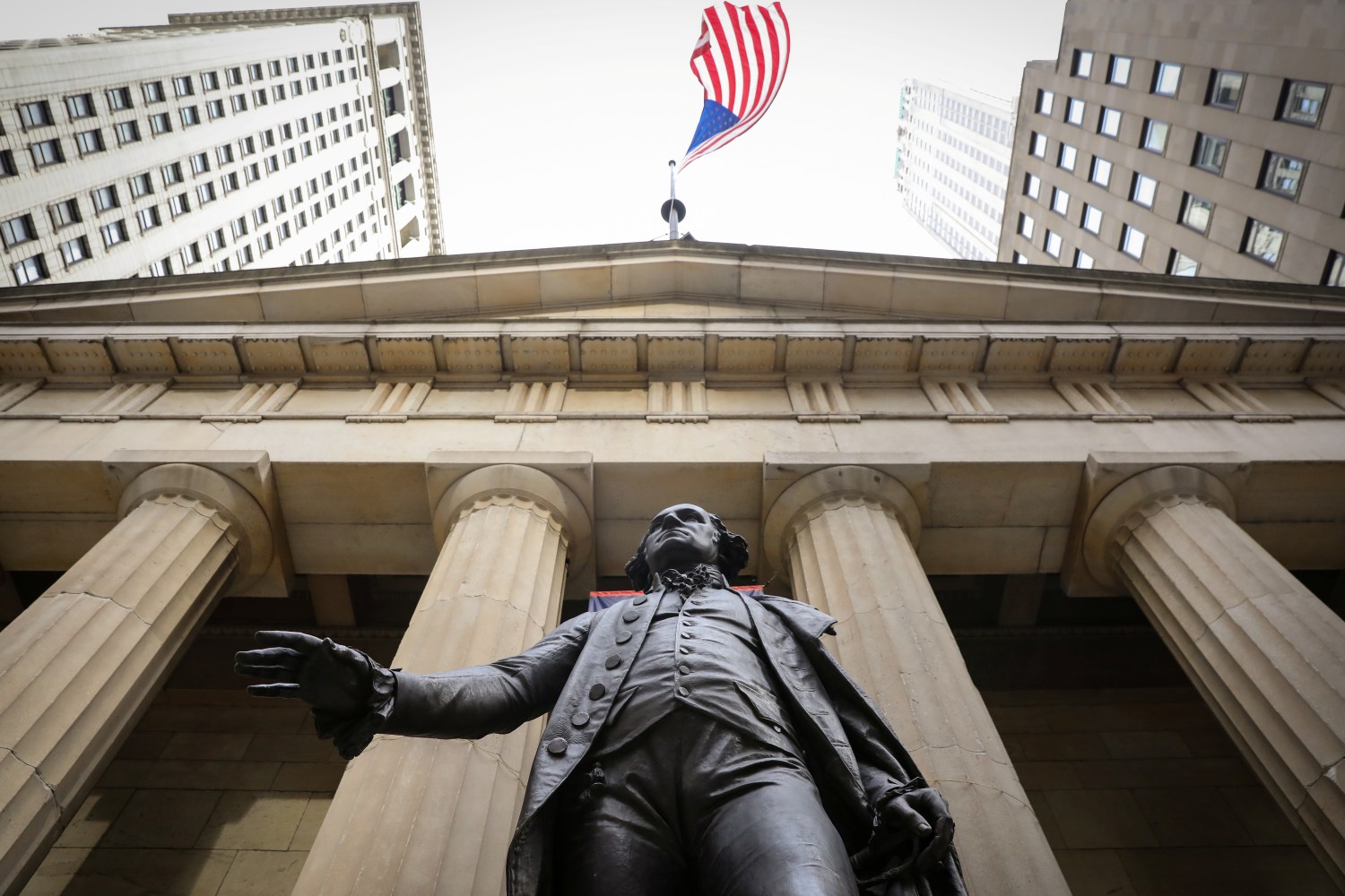 U.S. flag flies over a statue of George Washington outside Federal Hall National Memorial, as the partial U.S. government shutdown continues in New York