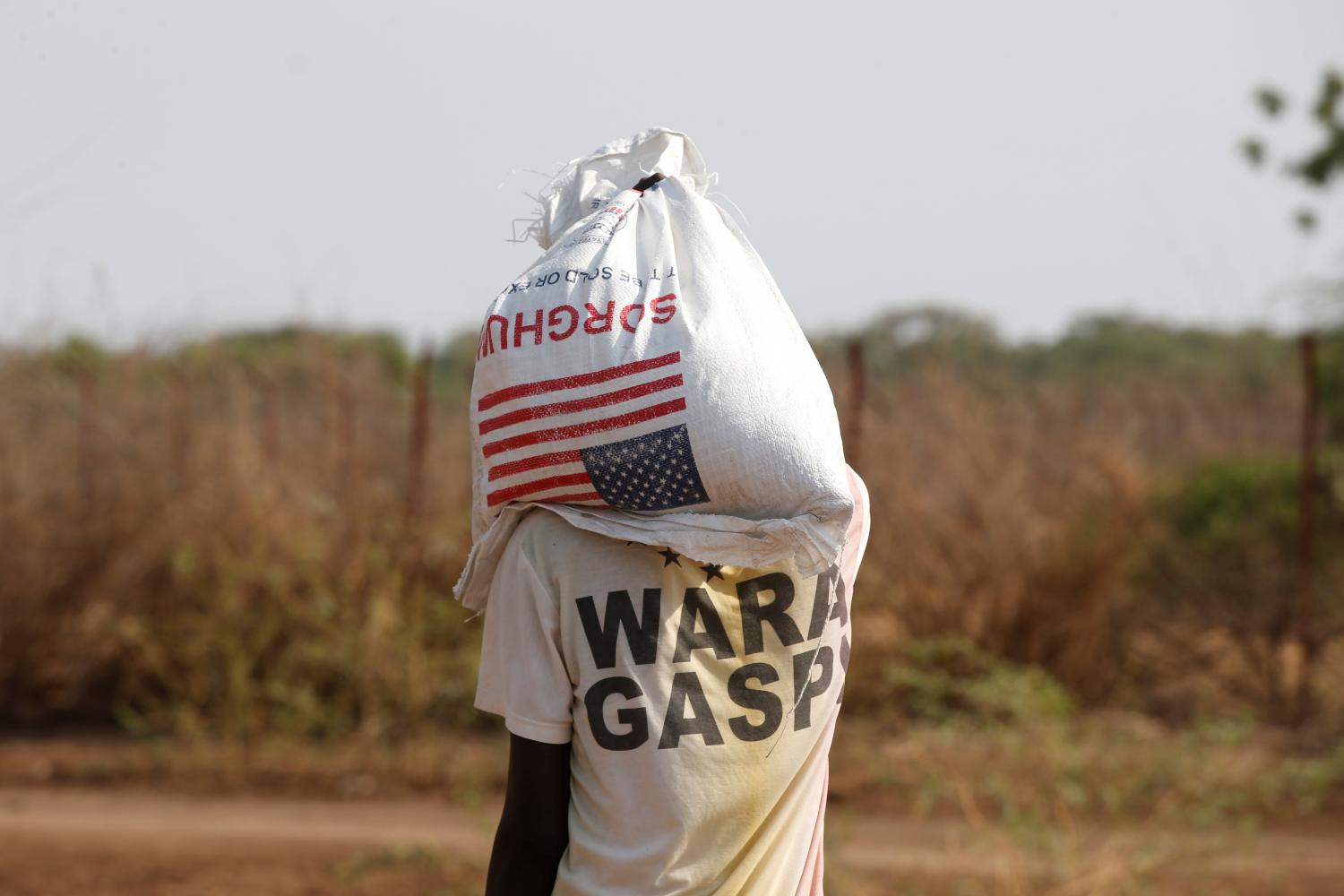 A man carries a bag of food aid at the Kakuma refugee camp in northern Kenya, March 6, 2018. Picture taken March 6, 2018. REUTERS/Baz Ratner - RC1A3D7798D0