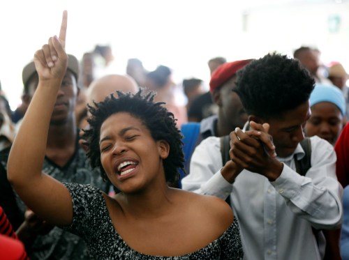 Students sing struggle songs during a gathering as Academic staff and church leaders protest demanding free tertiary education at Johannesburg's University of the Witwatersrand, South Africa, October 7, 2016. REUTERS/Siphiwe Sibeko  - D1AEUFPNKNAA