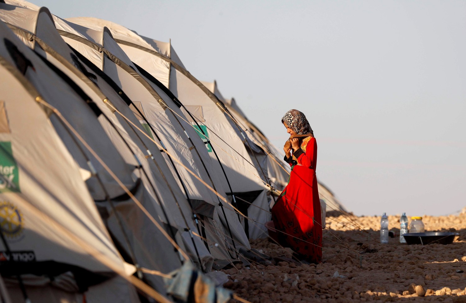 A girl walks towards her family's tent at a refugee camp for people displaced by fightings between the Syrian Democratic Forces and Islamic State militants in Ain Issa, Syria October 3, 2017.         REUTERS/Erik De Castro - RC182B251DD0
