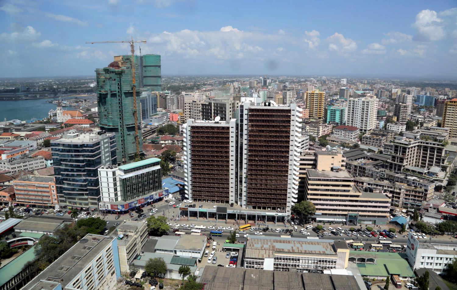 A general picture shows the skyline of Tanzania's port city of Dar es Salaam, July 12, 2013. Tanzania's commercial capital looks like a boom town even before cash rolls in from gas discoveries that in the next few years could make the east African nation a major energy exporter. Glass-clad tower blocks pierce Dar es Salaam's sky-line and more are emerging from noisy building sites. Billboards advertise high-definition televisions and other electronics to a new middle class, who crowd brand new shopping malls. REUTERS/Andrew Emmanuel (TANZANIA - Tags: SOCIETY BUSINESS ENERGY) - GM1E97C1S1L01