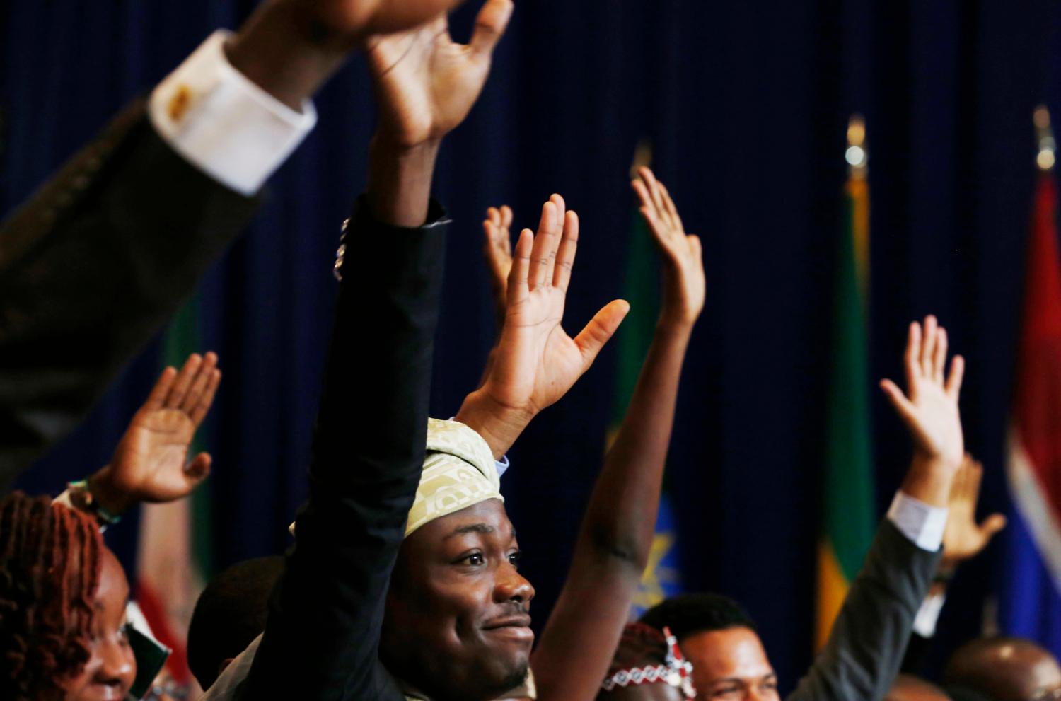 Vital Sounouvou (C) of Benin, raises his hand trying to be called on from U.S. President Barack Obama, at the Summit of the Washington Fellowship for Young African Leaders at the Omni Shoreham Hotel in Washington, July 28, 2014.     REUTERS/Larry Downing   (UNITED STATES - Tags: POLITICS EDUCATION) - GM1EA7T017E01